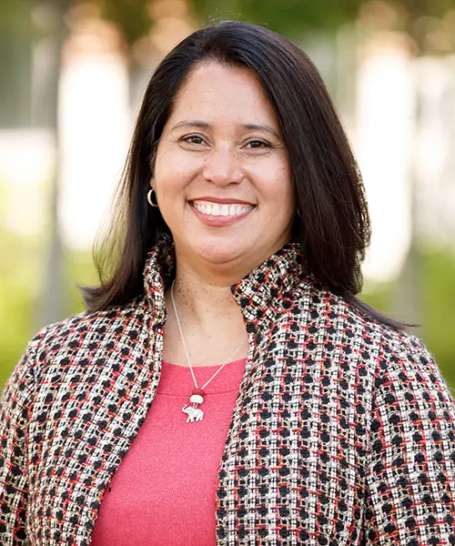 headshot of cathy bolling wearing a pink shirt and a plaid jacket