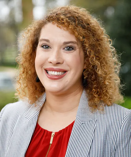 headshot of kendra powell wearing a striped sweater